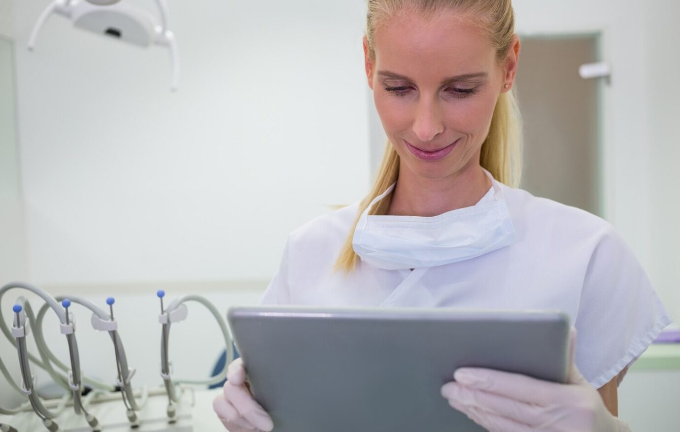 female-dentist-using-digital-tablet_107420-73929